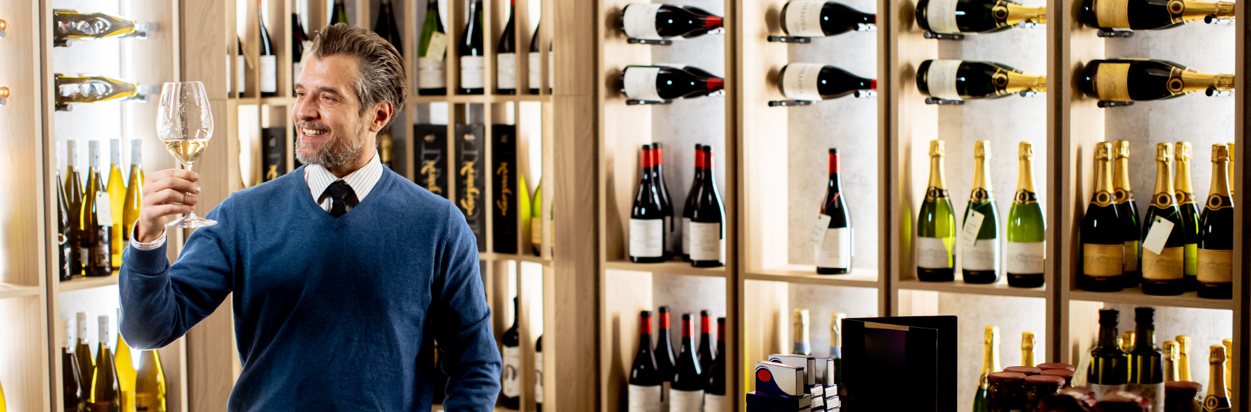 A wine and spirits buyer and sommelier examining a bottle